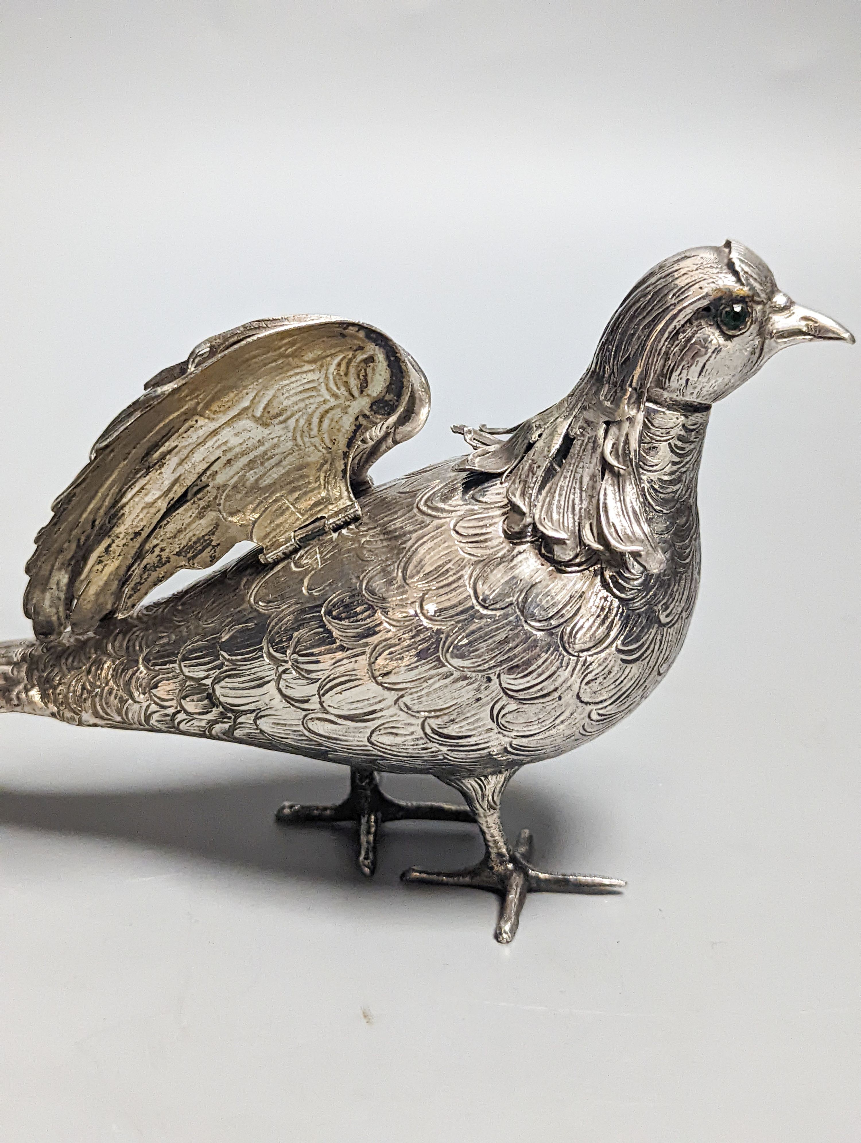A late 19th century Hanau 800 white metal novelty condiment?, modelled as a game bird, with articulated wings and removable head, 22.4cm, gross 139 grams.